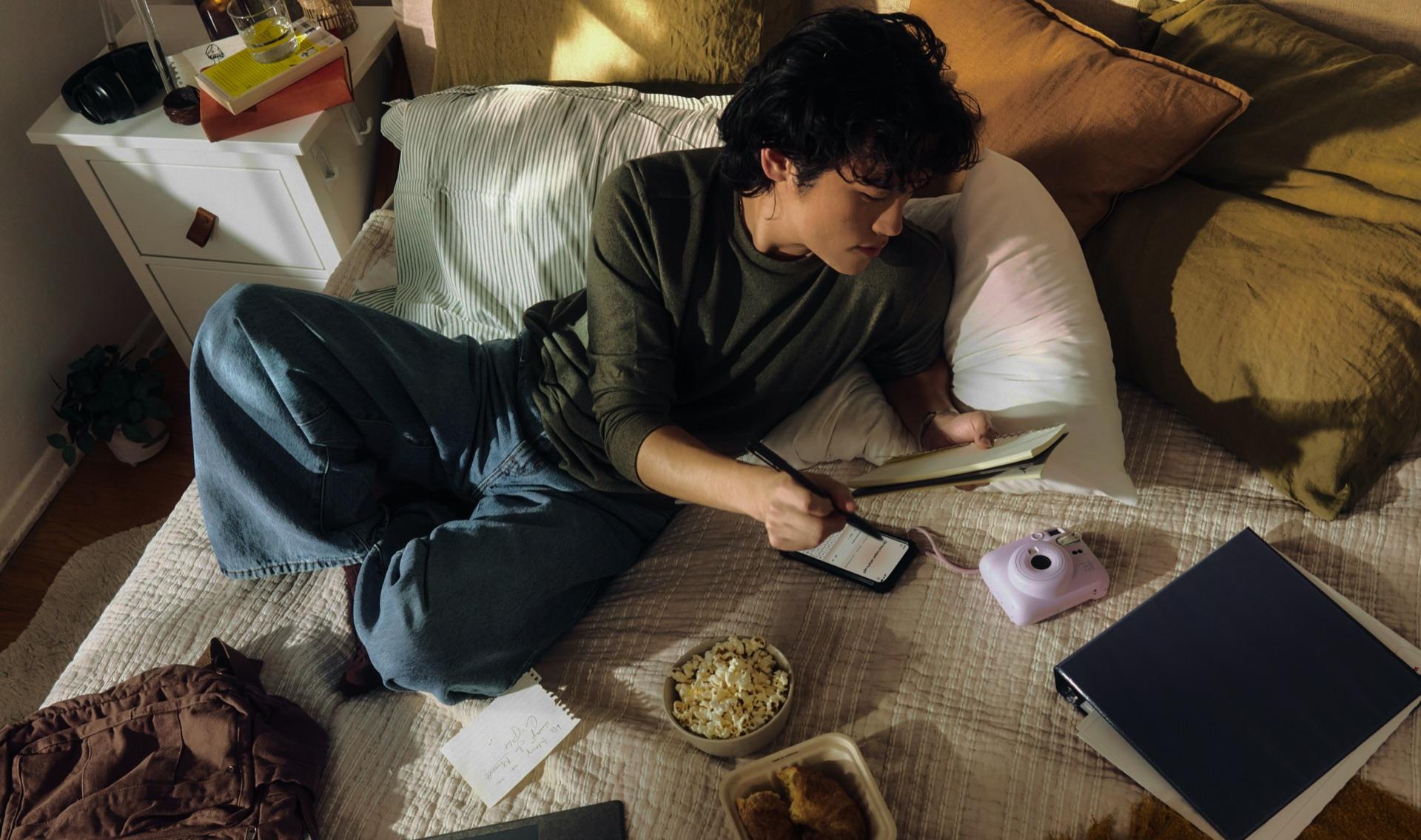 Student studying on a bed